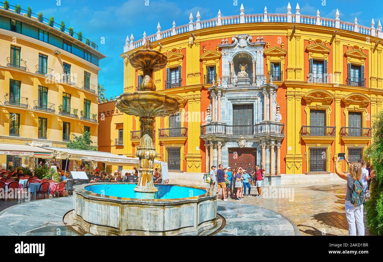 MALAGA, SPAIN - SEPTEMBER 26, 2019: Architectural ensemble of Plaza Obispo square with Baroque Palacio Episcopal (Bishop's palace) and stone fountain Stock Photo