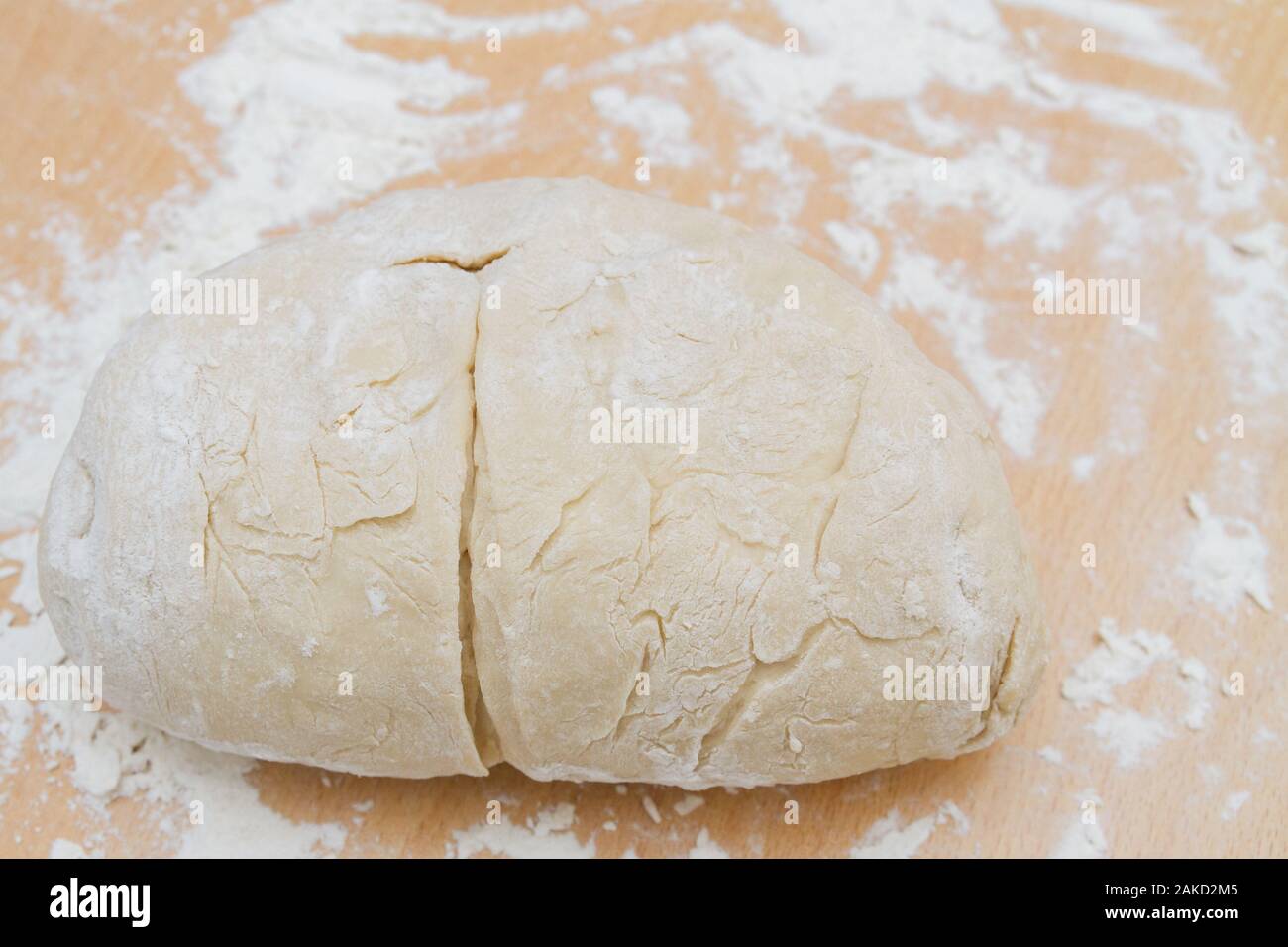 Prepared kneaded dough on a wooden table at home Stock Photo - Alamy