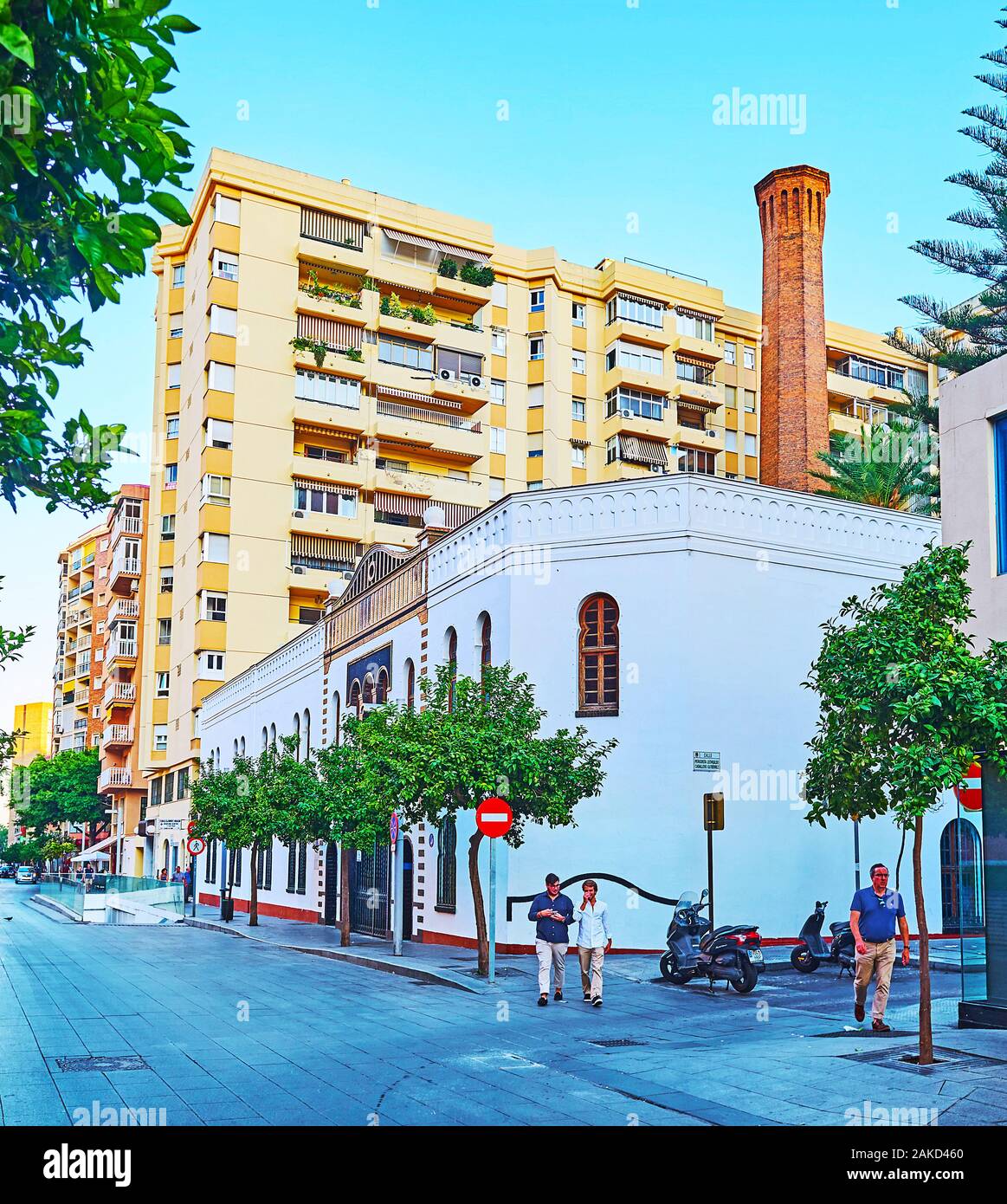 MALAGA, SPAIN - SEPTEMBER 26, 2019: Walk Calle Maestranza (street), lined with modern residential high rises and green trees with a view on extant bui Stock Photo