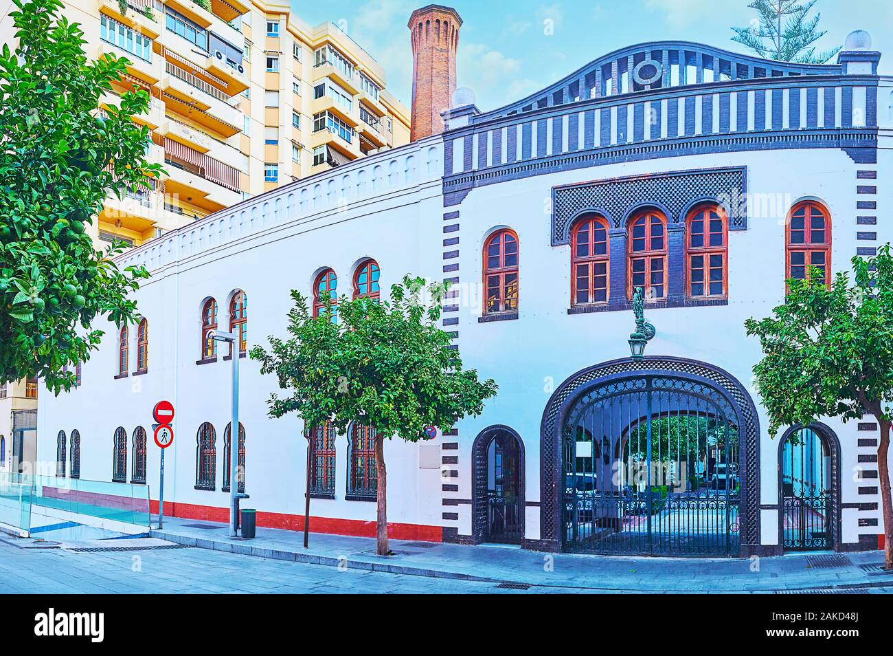 The vintage facade of former factory building, nowadays serving as the office complex, located in Calle Maestranza, Malaga, Spain Stock Photo