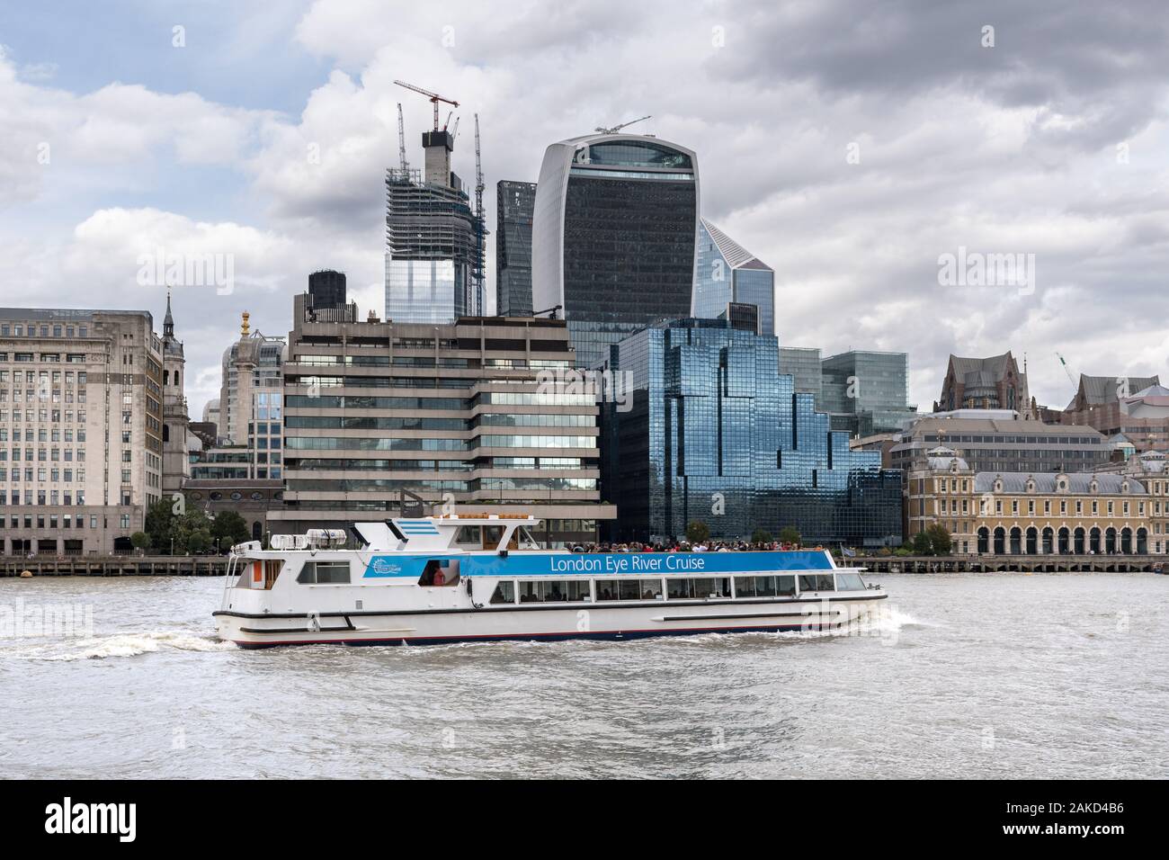 A London Eye River Cruise boat sailing on the river Thames with passengers aboard on a sightseeing tour, London, UK Stock Photo