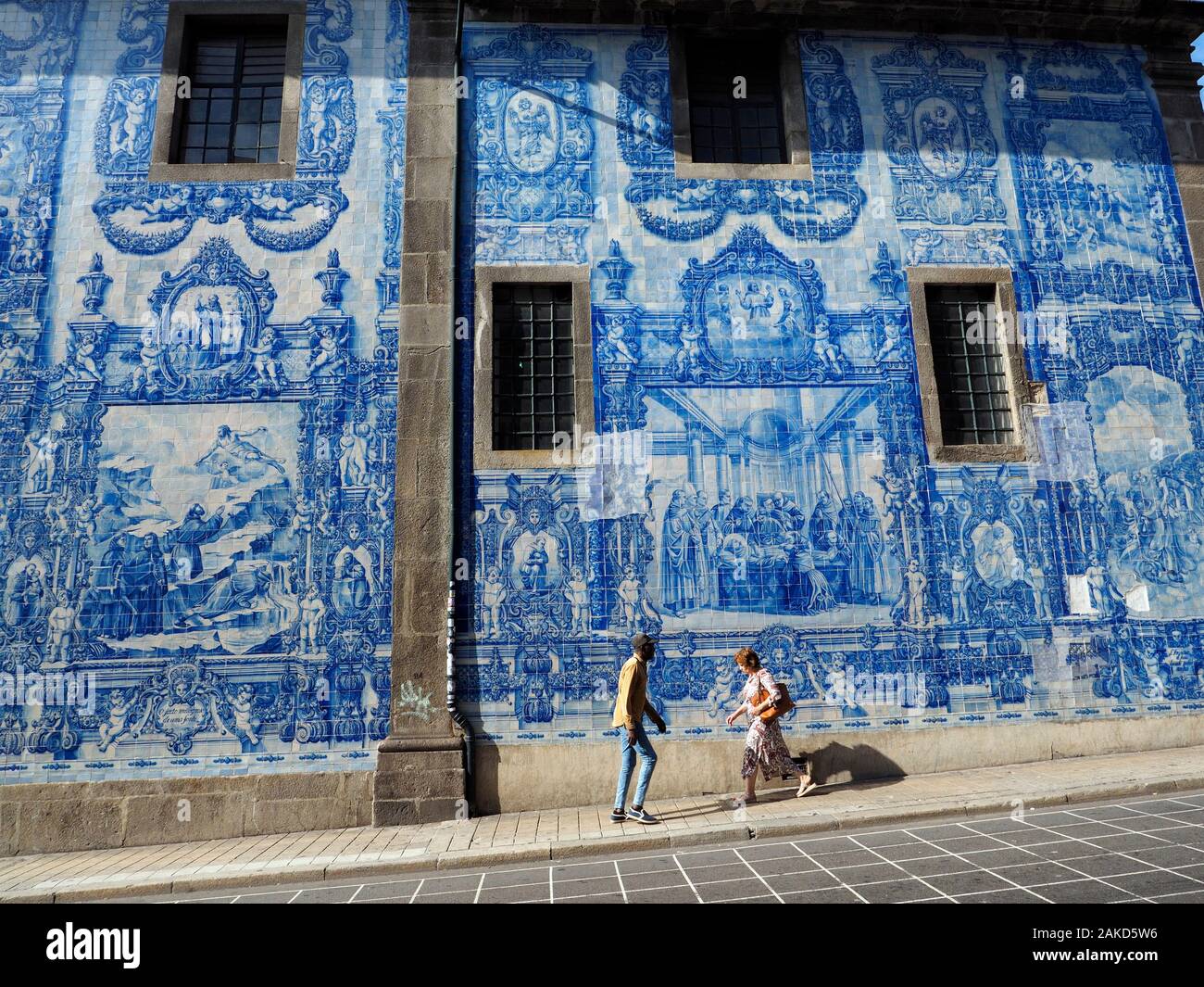 Side wall of a church decorated with traditional Portugese azulejos, blue and white tiles. Porto, Portugal Stock Photo