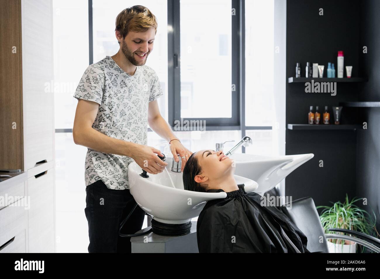 Woman getting hair treatment in a spa salon using shampoo for hair, beauty  salon, hair wash Stock Photo - Alamy