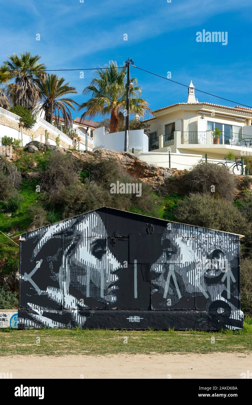 urban street art painted on a fishermans hut on the beach at Ferragudo, Portugal Stock Photo