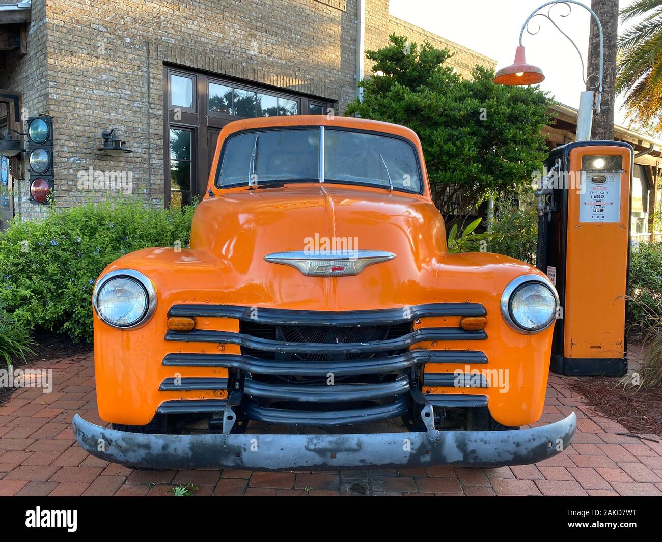 vintage old antique truck at gas station with cobblestone path front view Stock Photo