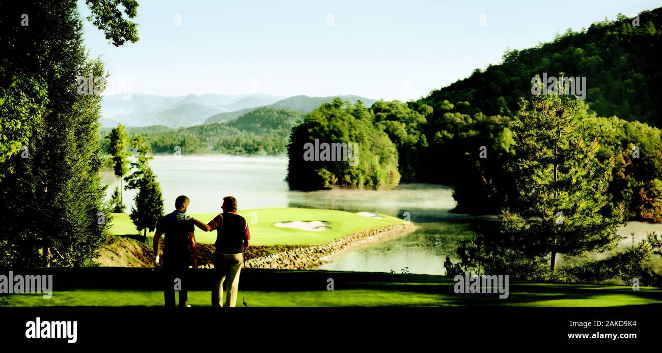 Friends playing golf on a golf course. Stock Photo