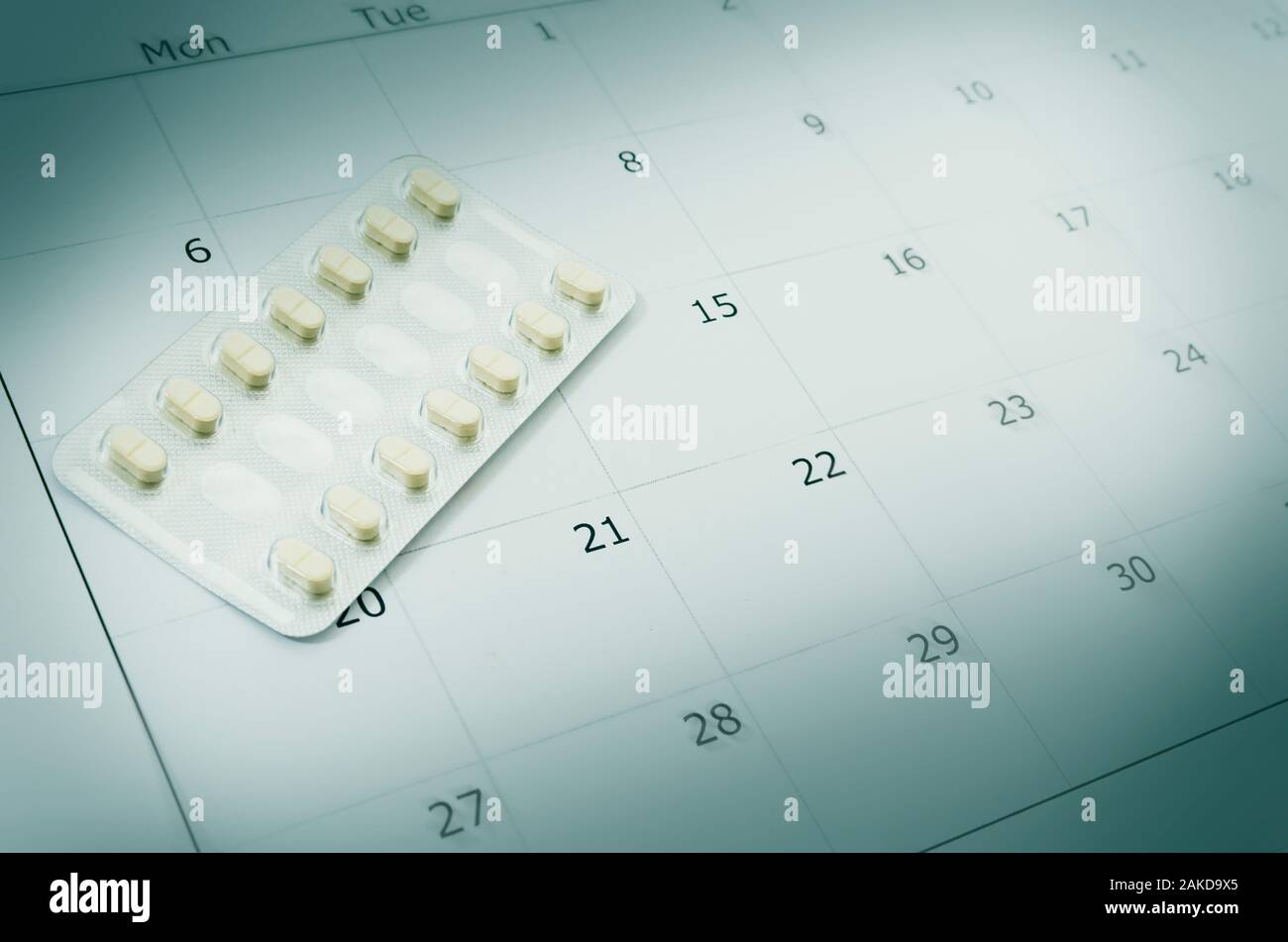 Close up birth control pill with date of calendar background, health care and medicine concept. Selective focus Stock Photo