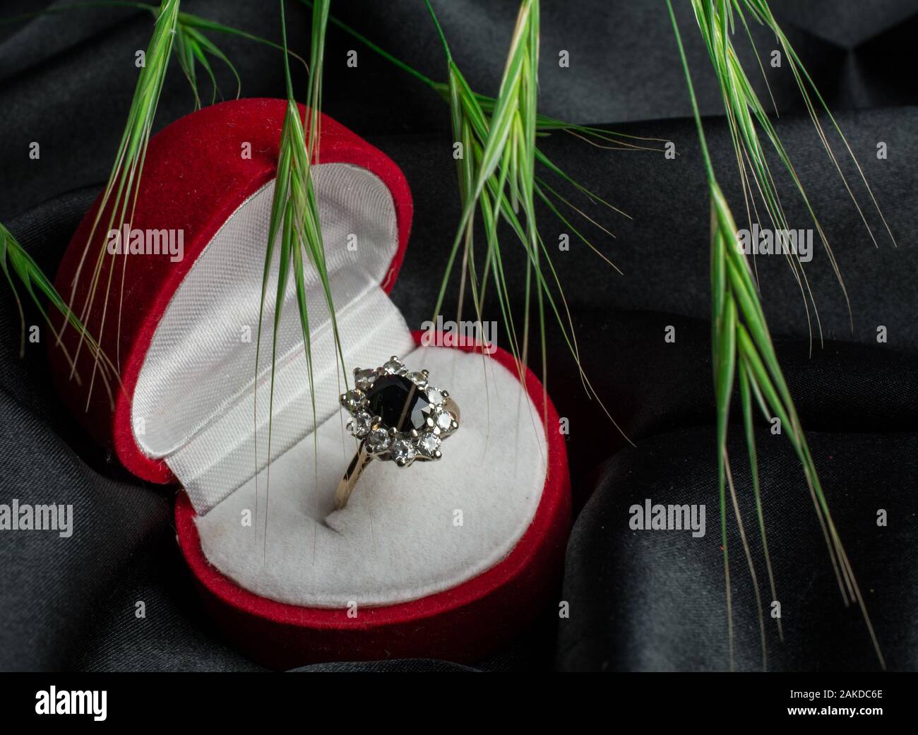 gold ring in box on red black backgroung Stock Photo - Alamy