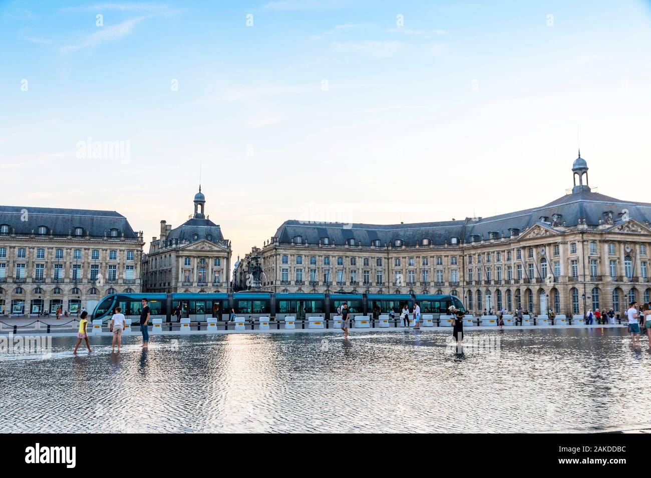 Bordeaux, France - June 13, 2017: People walks on near water mirror fountain on Place de la Bourse in Bordeaux, Nouvelle-Aquitaine region, France. One Stock Photo