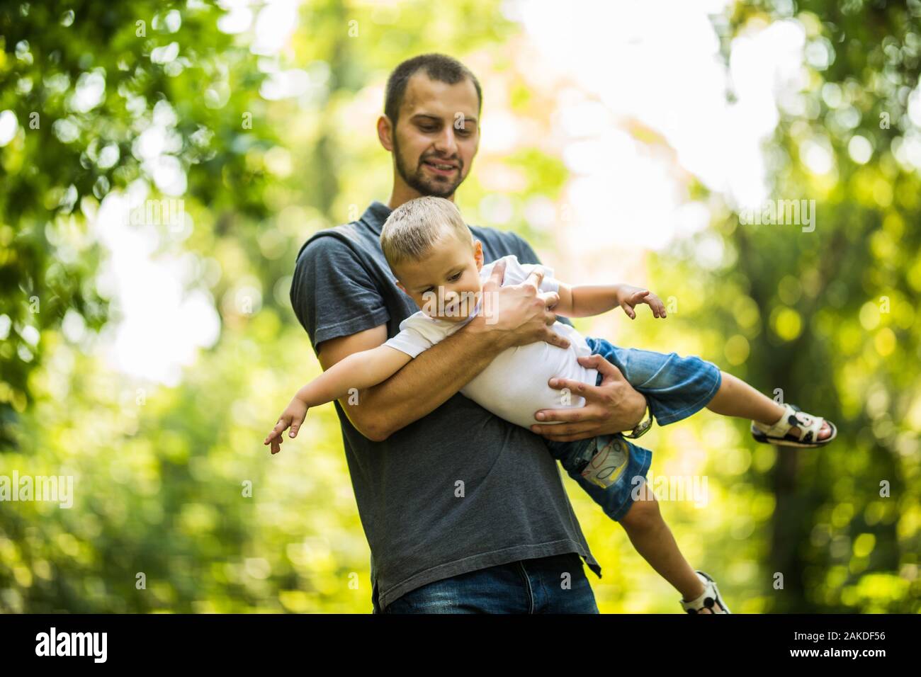 happy father and son are playing in the park Stock Photo - Alamy