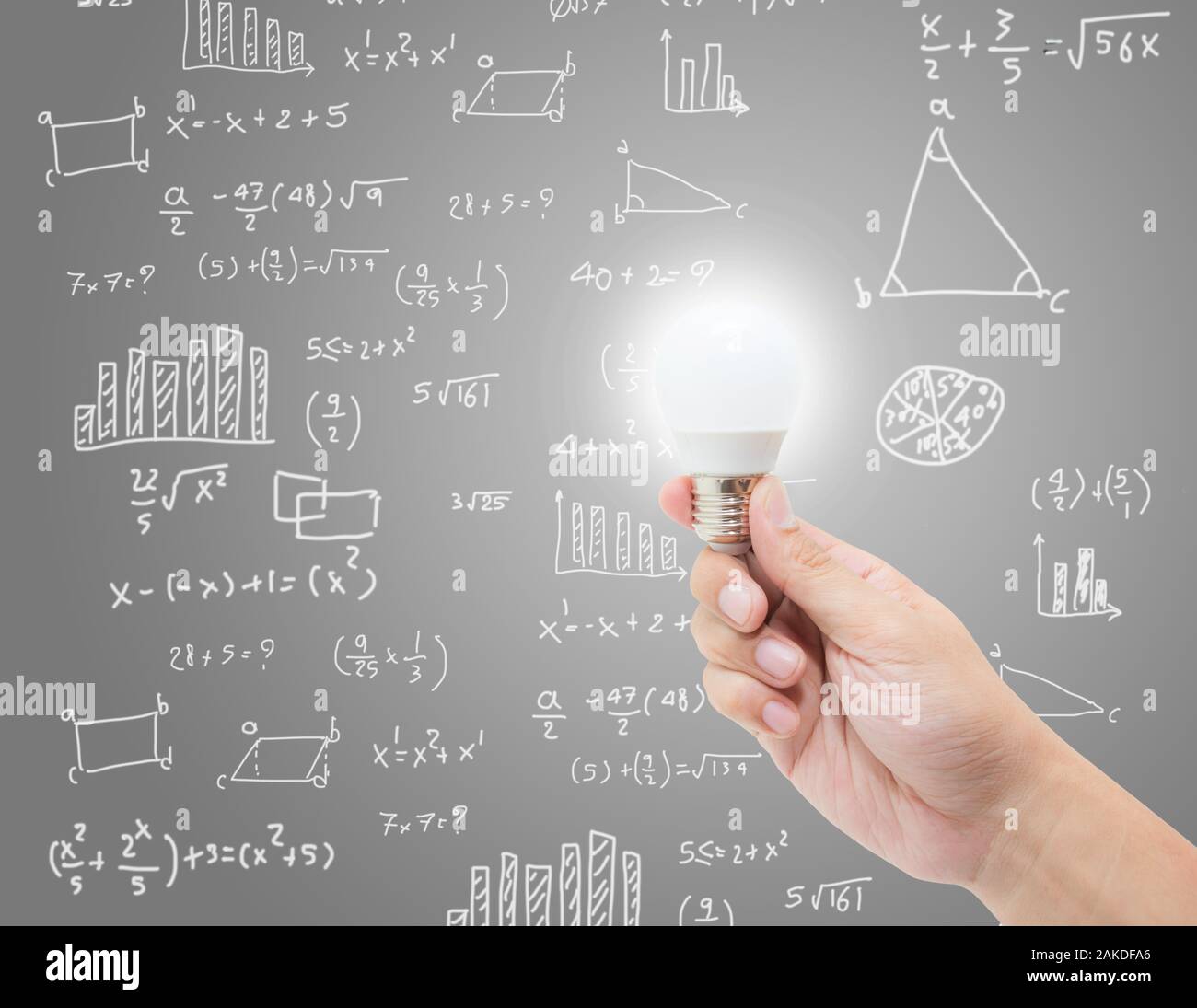 hand hold lightbulb with brainstorm creative idea on math formula background, knowledge and innovation with chart for analysis, success concept. Stock Photo