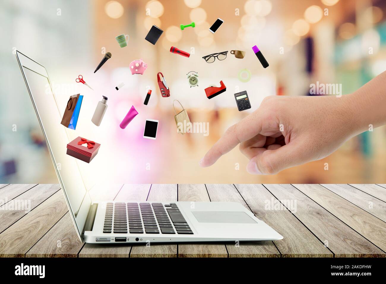 Eervol ethiek Overleven Shopping cart and laptop computer with products on wood bokeh background, shop  online concept Stock Photo - Alamy
