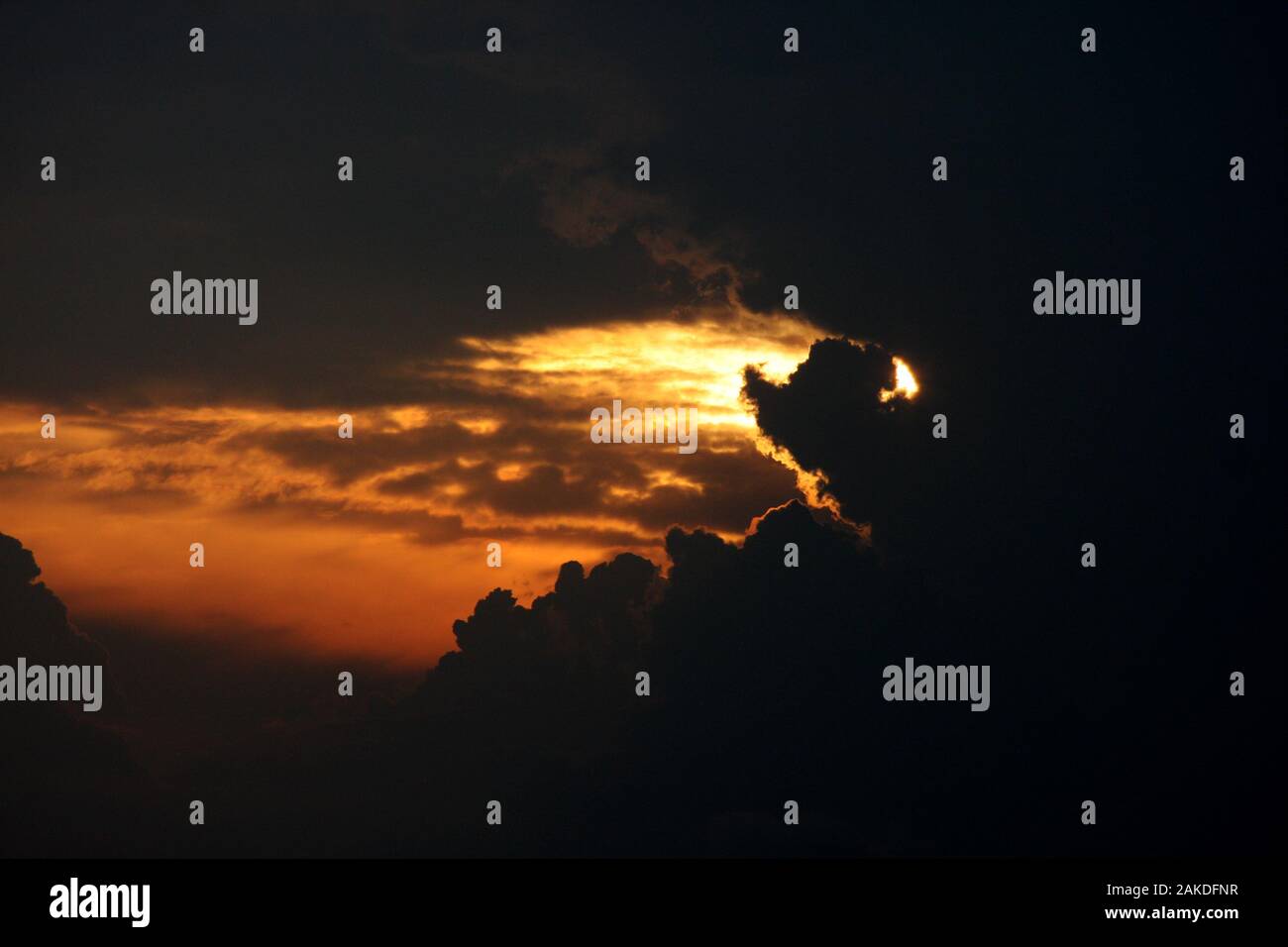 Dramatic sunset with red sky and dark clouds Stock Photo - Alamy