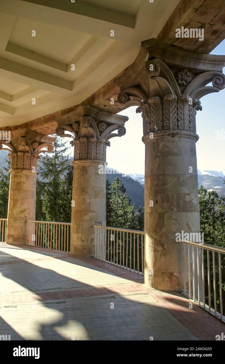 Bearing classical columns framing an oval balcony on the corner of the building of the sanatorium 'Mountain Armenia' in the resort of Dilijan Stock Photo