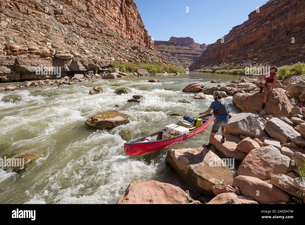 Lining a canoe around Government Rapid on the San Juan River, Utah. Stock Photo