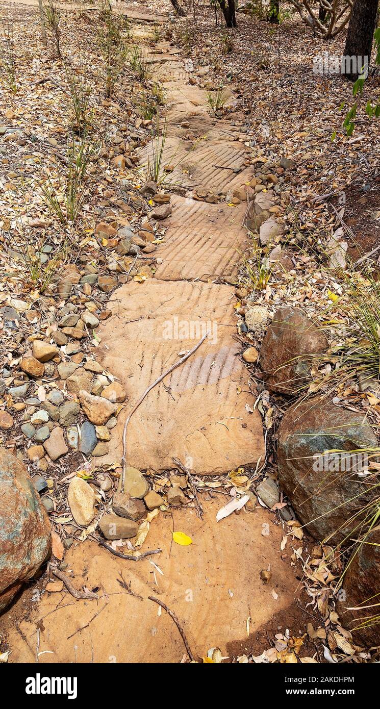 A rough footpath of stepping stones laid amongst gravel on dry rocky ground Stock Photo