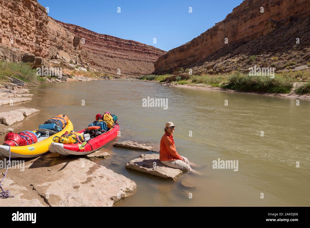 Woman relaxing on the shore of the San Juan River in Southern Utah. Stock Photo