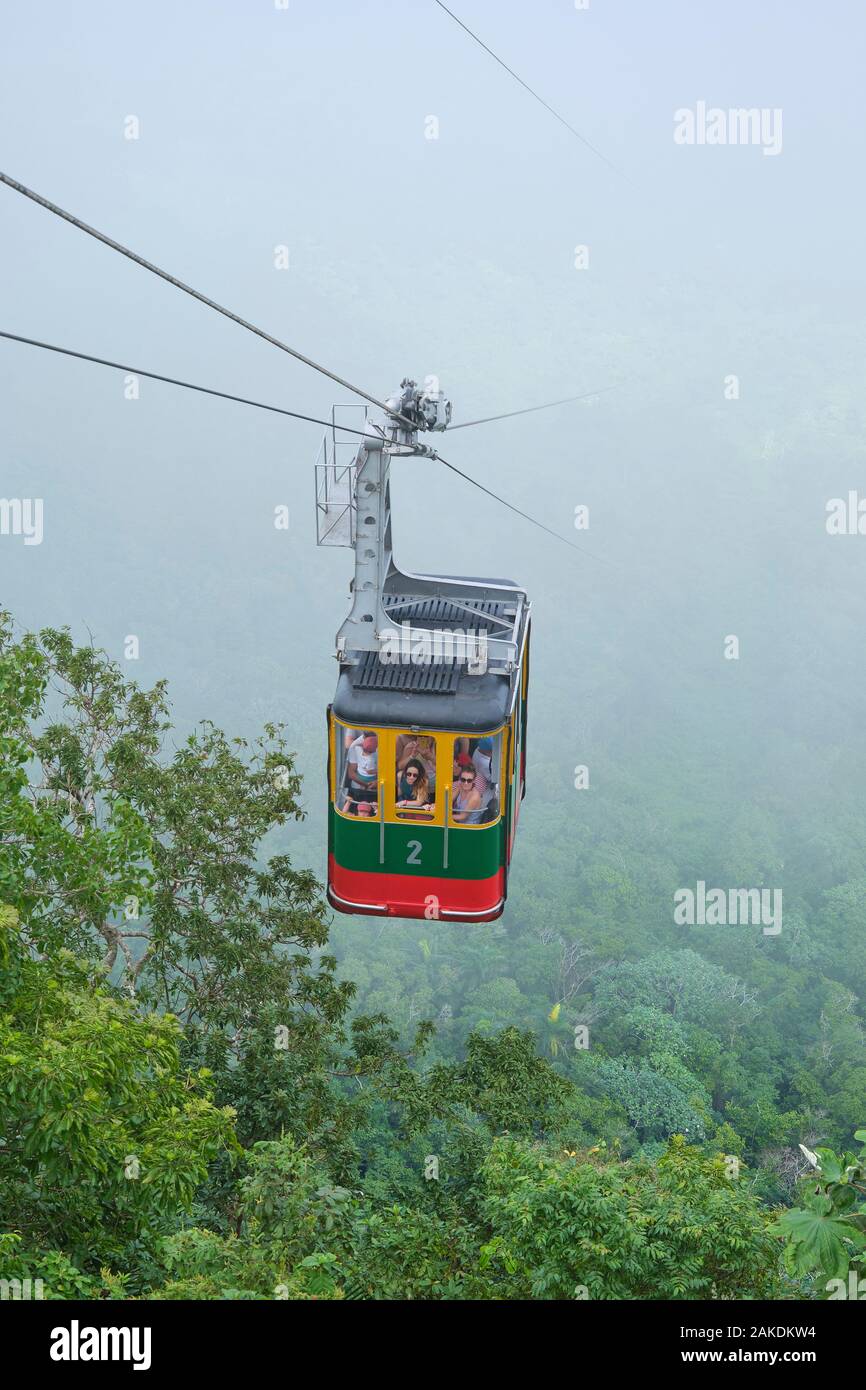 Cable car emerges out of the mist and fog as it ascends to the summit of Mount Isabel de Torres in Puerto Plata Dominican Republic. Stock Photo