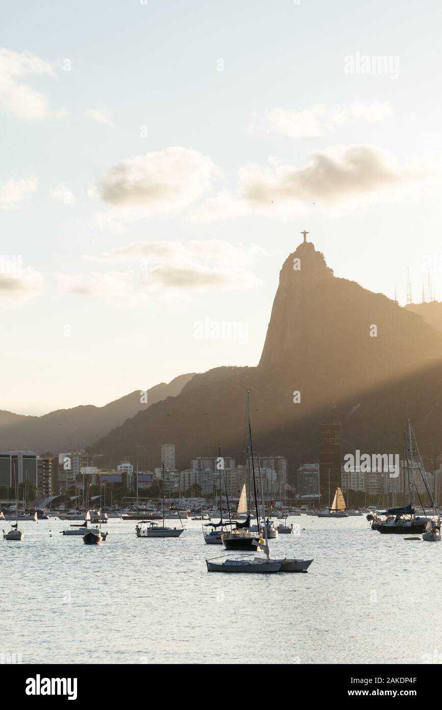 Sunset from Mureta da Urca in Rio de Janeiro, over the mountains and Christ the Redeemer Statue. Stock Photo