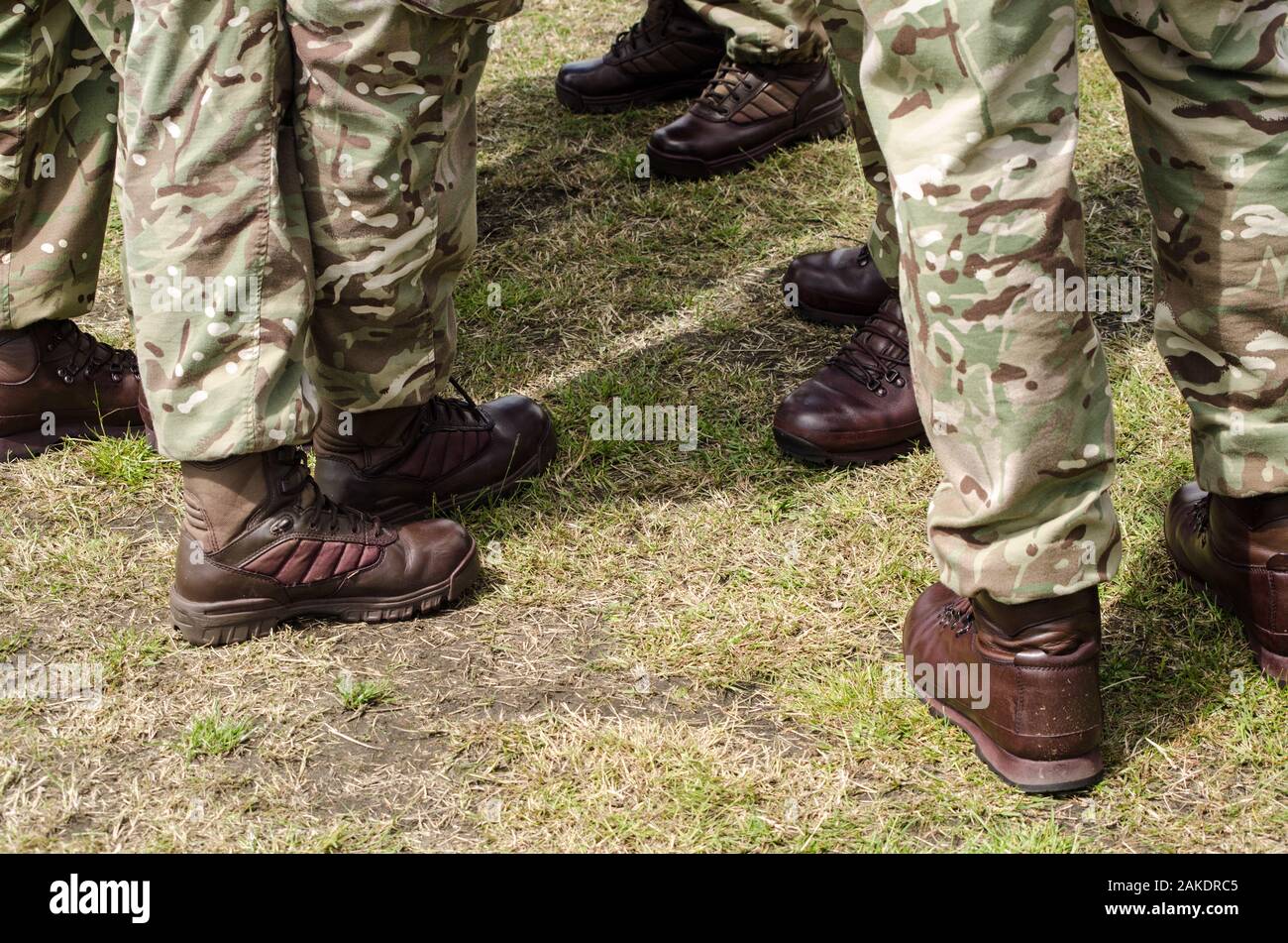 Brown boots worn by British soldiers with their camouflage uniform. Stock Photo