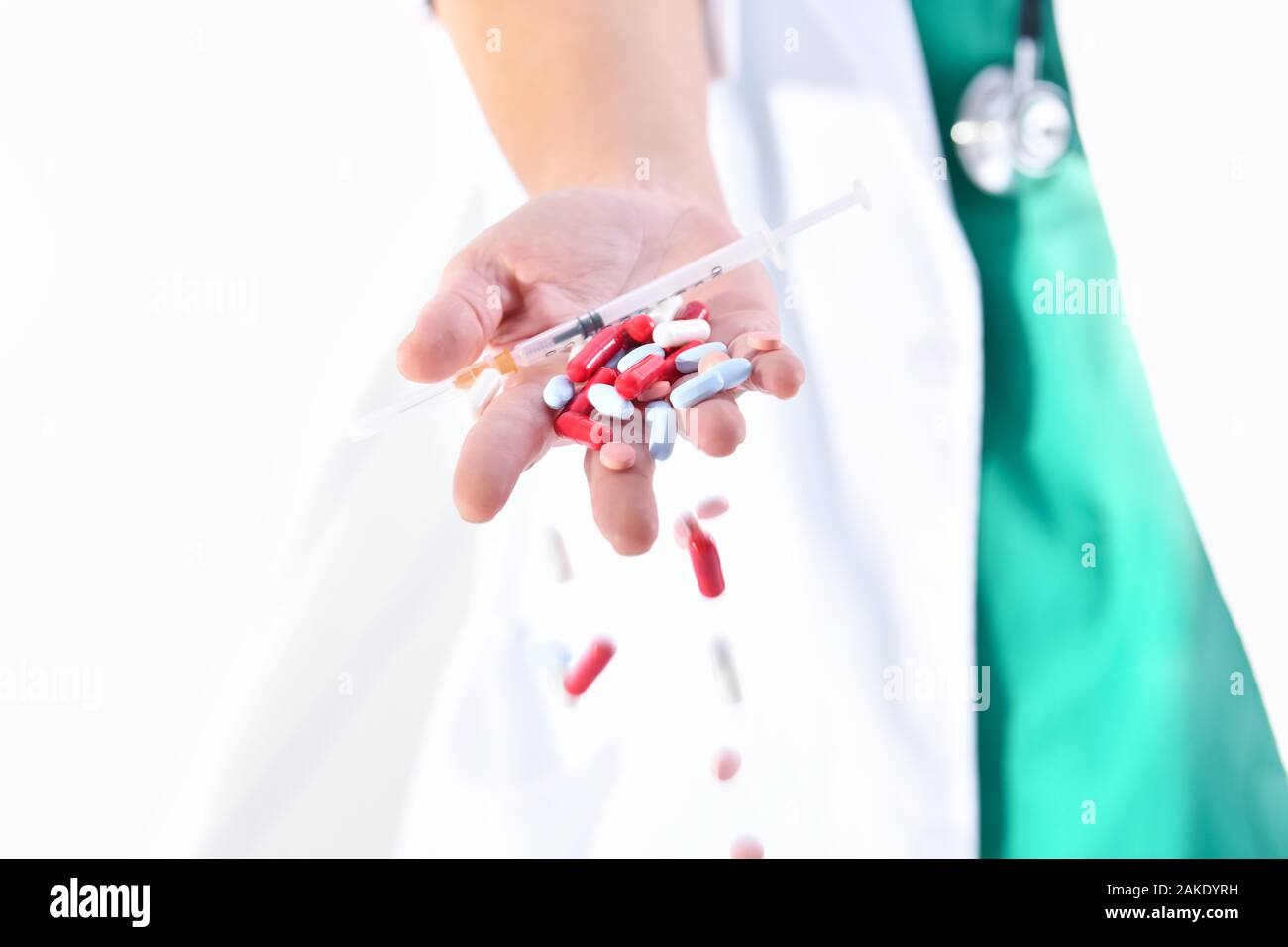 doctor hand dropping assorted pills and capsules Stock Photo