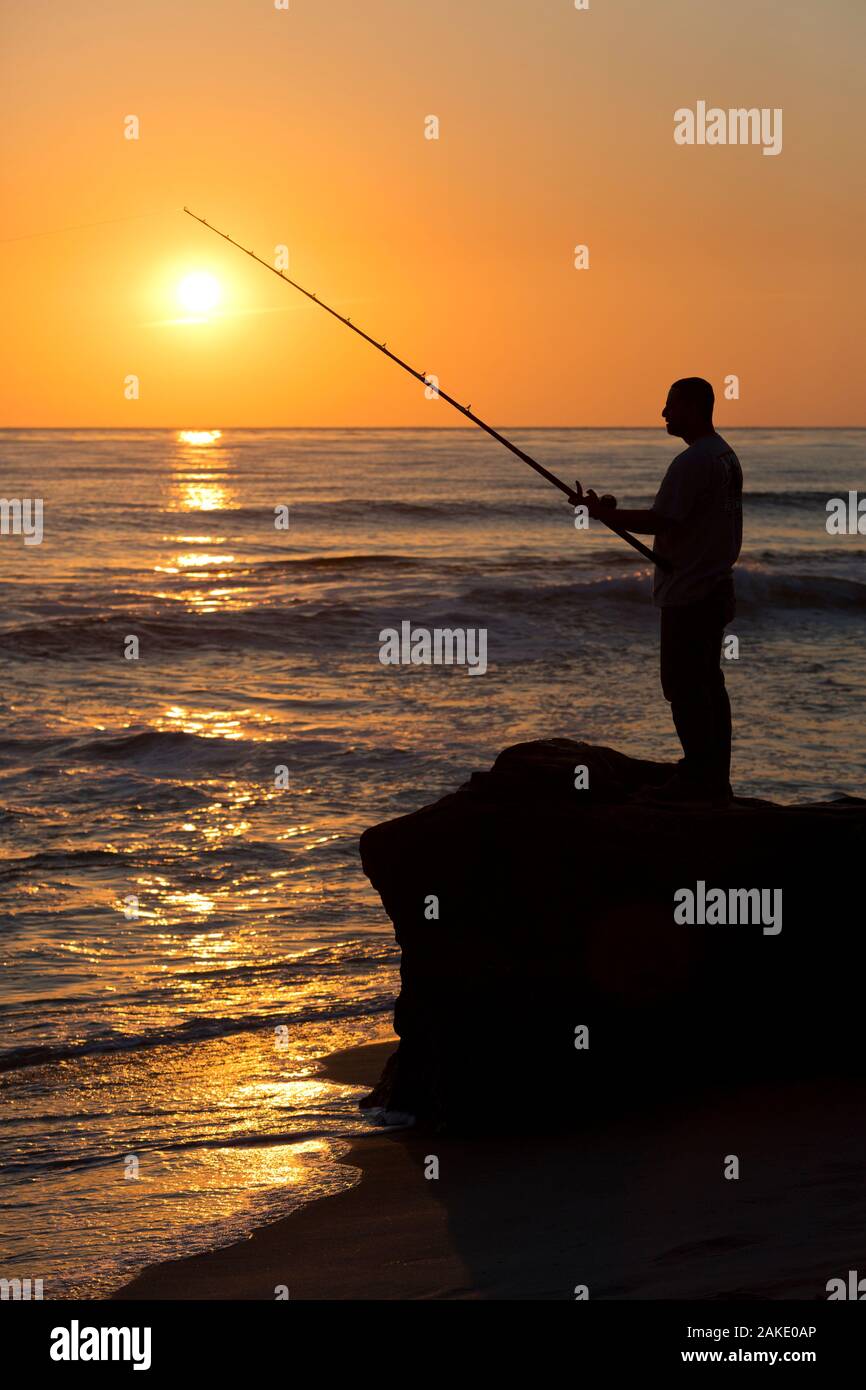 Man Surf Fishing at Sunset, La Jolla, California Stock Photo