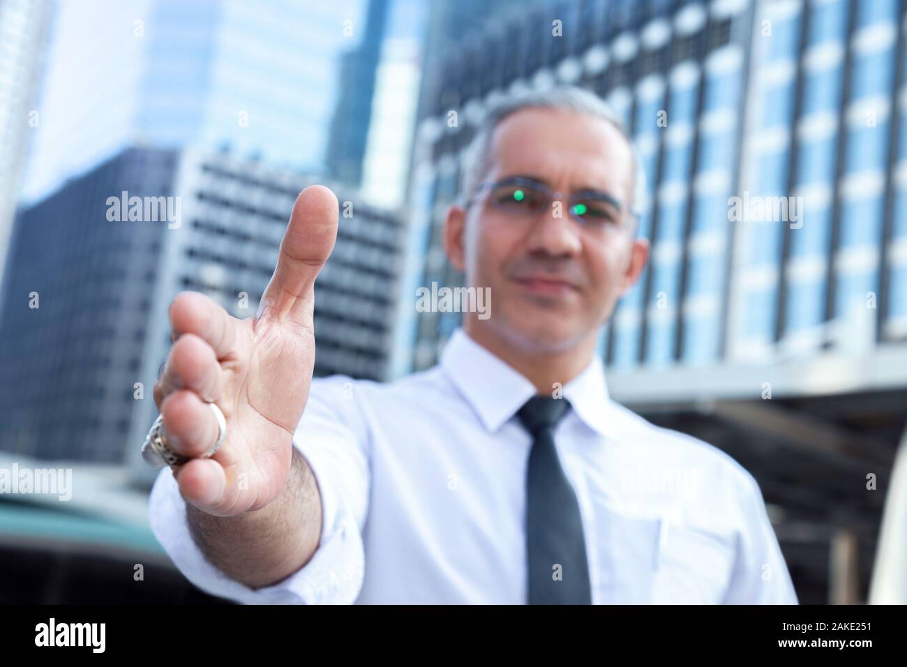 success businessman professional making handshake in front of office