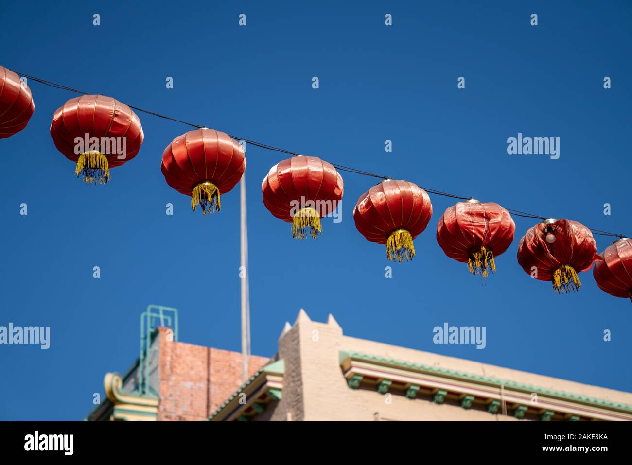 Multiple Chinese lanterns hanging amidst blue sky in city Stock Photo ...