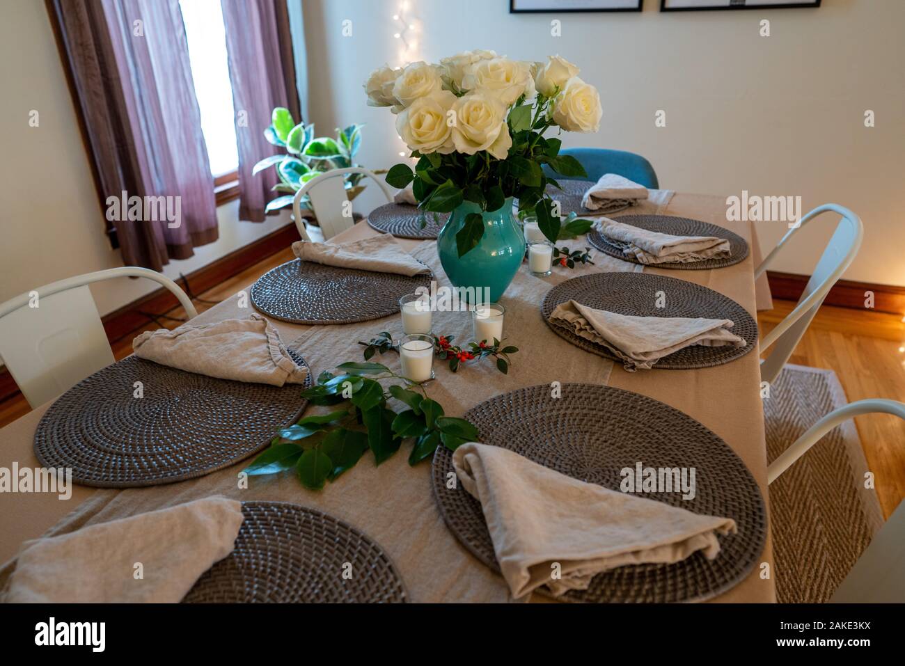 Dinner table prepared at a home with flowers and simple setting Stock Photo