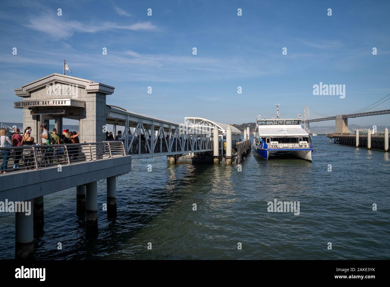 Ferry docking at San Francisco Bay Ferry Gate G with passengers in long line Stock Photo