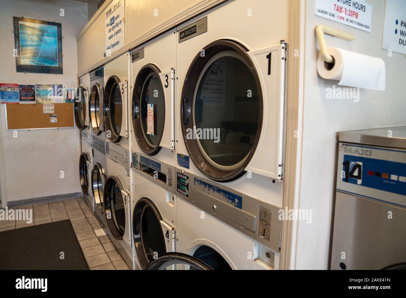 Rows of washing and drying machines at a laundromart Stock Photo