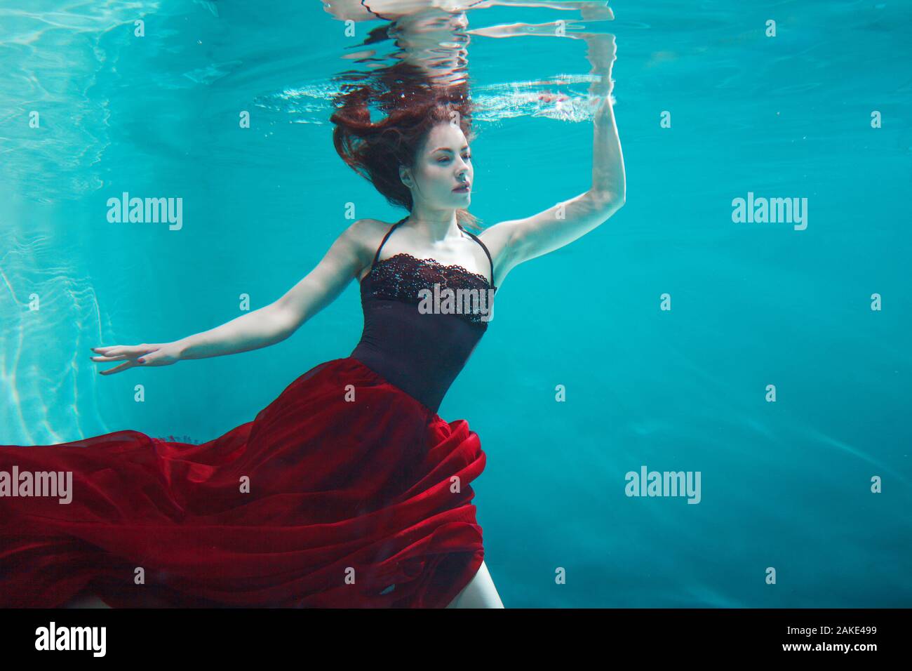 Beautiful girl in a red dress swims under water. amazing Underwater beauty photo Stock Photo Alamy