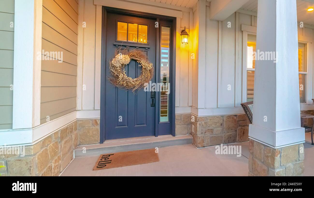 Panorama Front and sidelight of home with front porch and wood siding exetrior wall Stock Photo