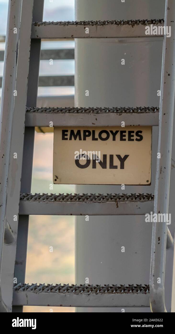 Vertical frame Park City Utah in summer with Employees Only sign and ladder under chairlifts Stock Photo