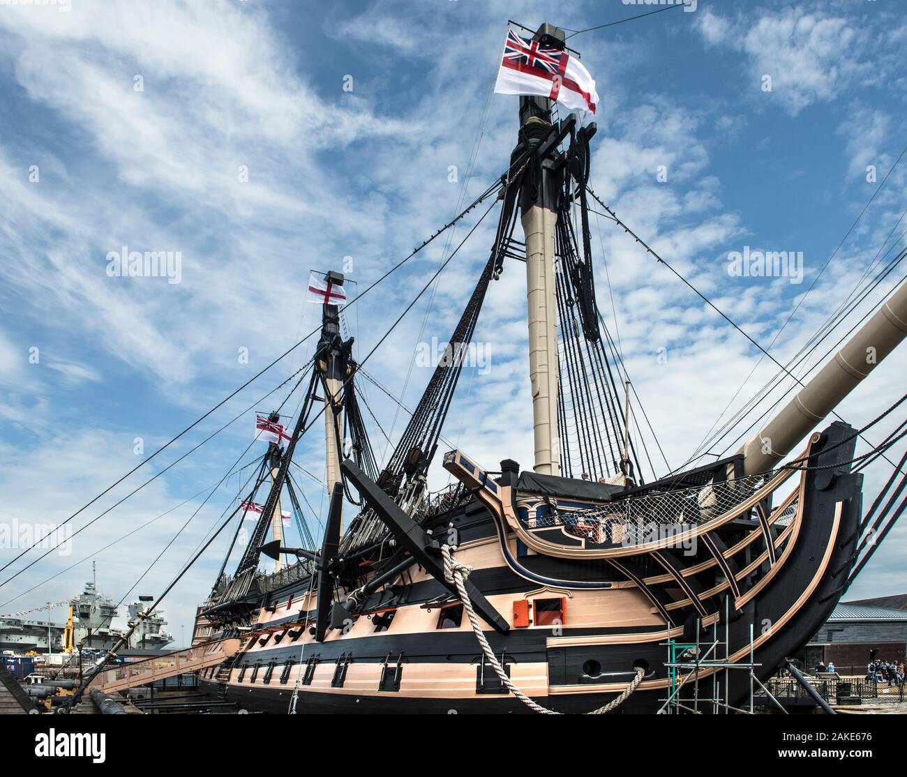 HMS Victory, historic flagship. Nelson. Battle of Trafalgar, flying the White Ensign. Portsmouth Dockyard. Starboard. Queen Elizabeth aircraft carrier. Stock Photo