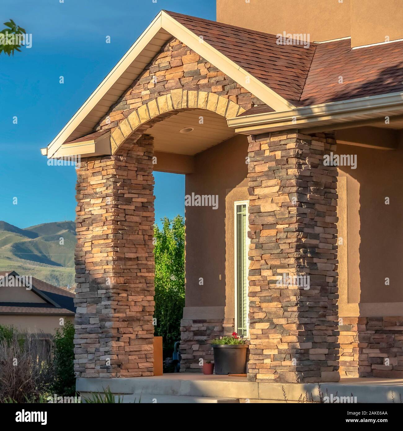 Square Facade Of Home With Stirs Arched Entrance And Stone Brick Columns On Porch Stock Photo Alamy