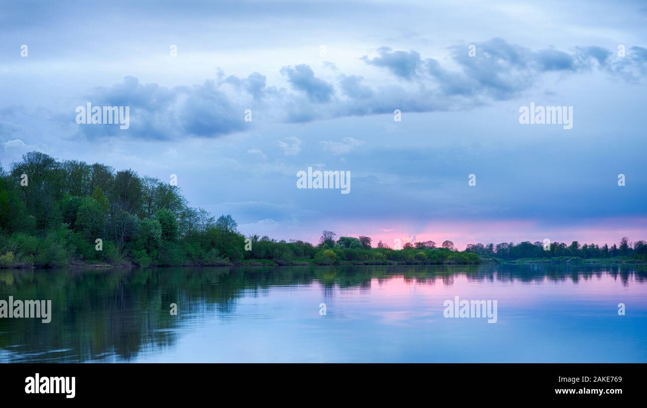 Colorful sunset in the river with reflex Stock Photo - Alamy