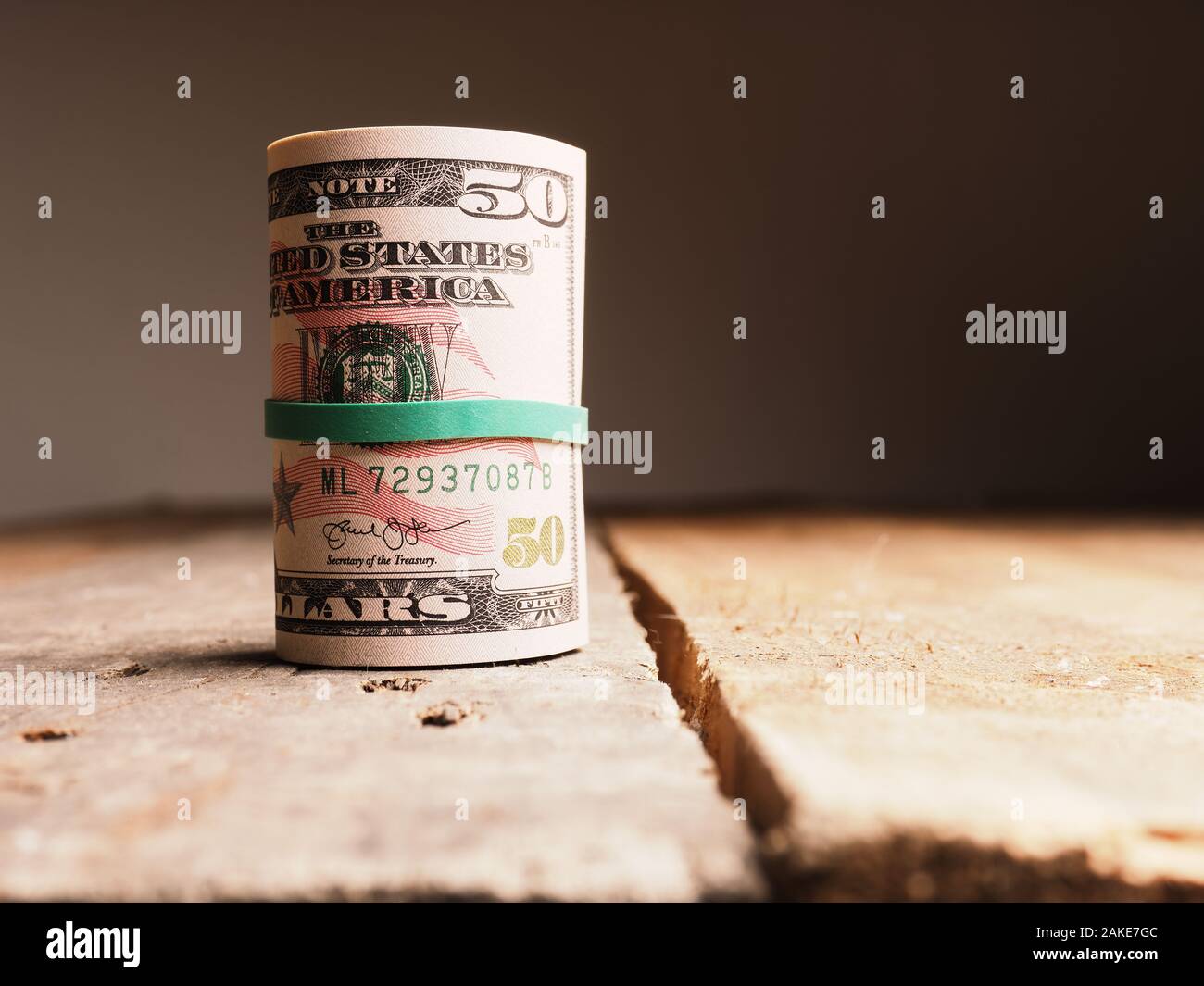 Different Dollar banknotes on a rustic wooden table, Income or savings ...