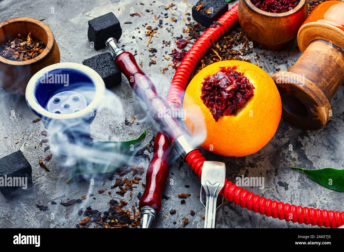 Smoking hookah pipe with mouthpiece and citrus flavored shisha tobacco