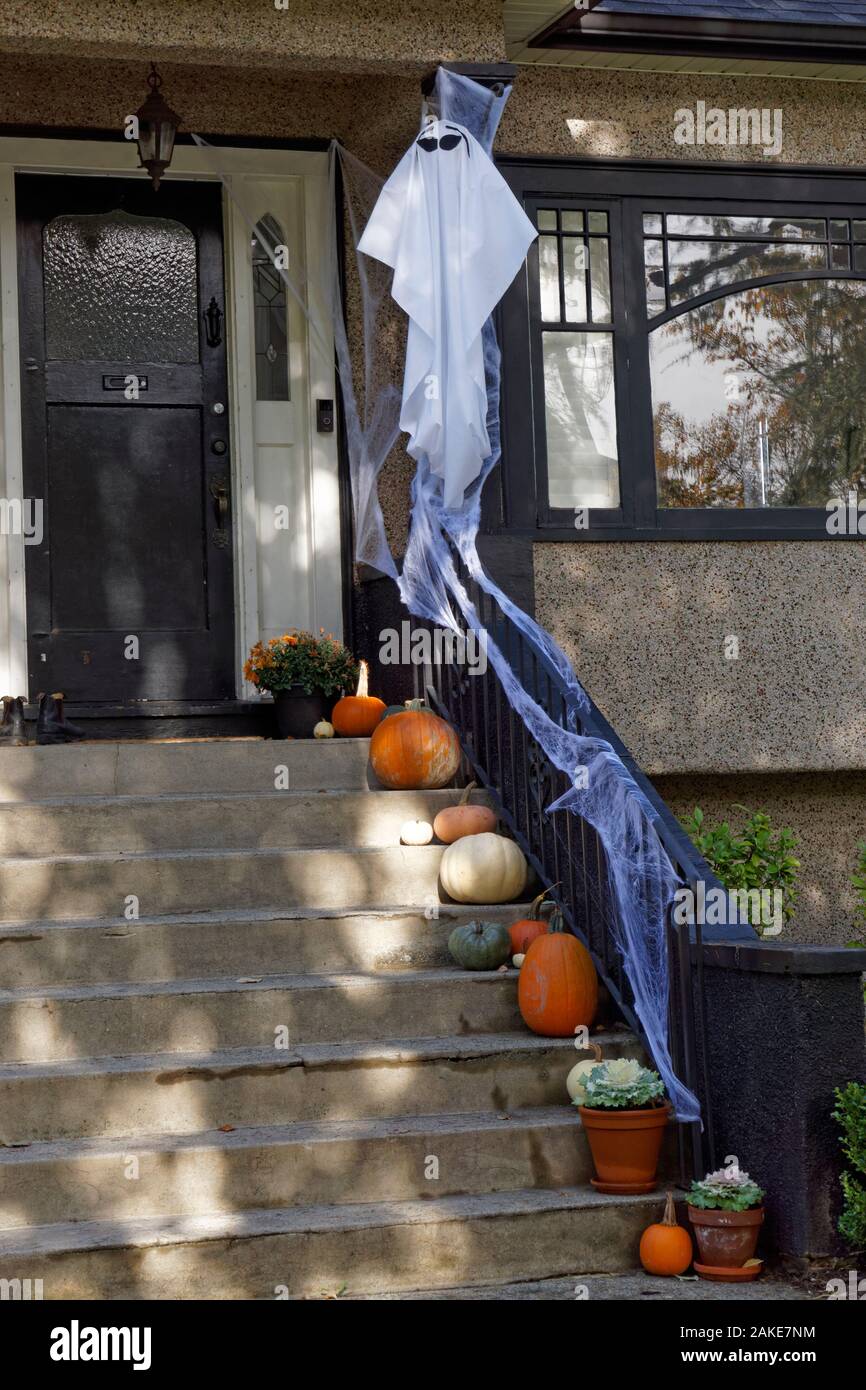 Pumpkins and Halloween decorations on the front steps of a house Stock Photo