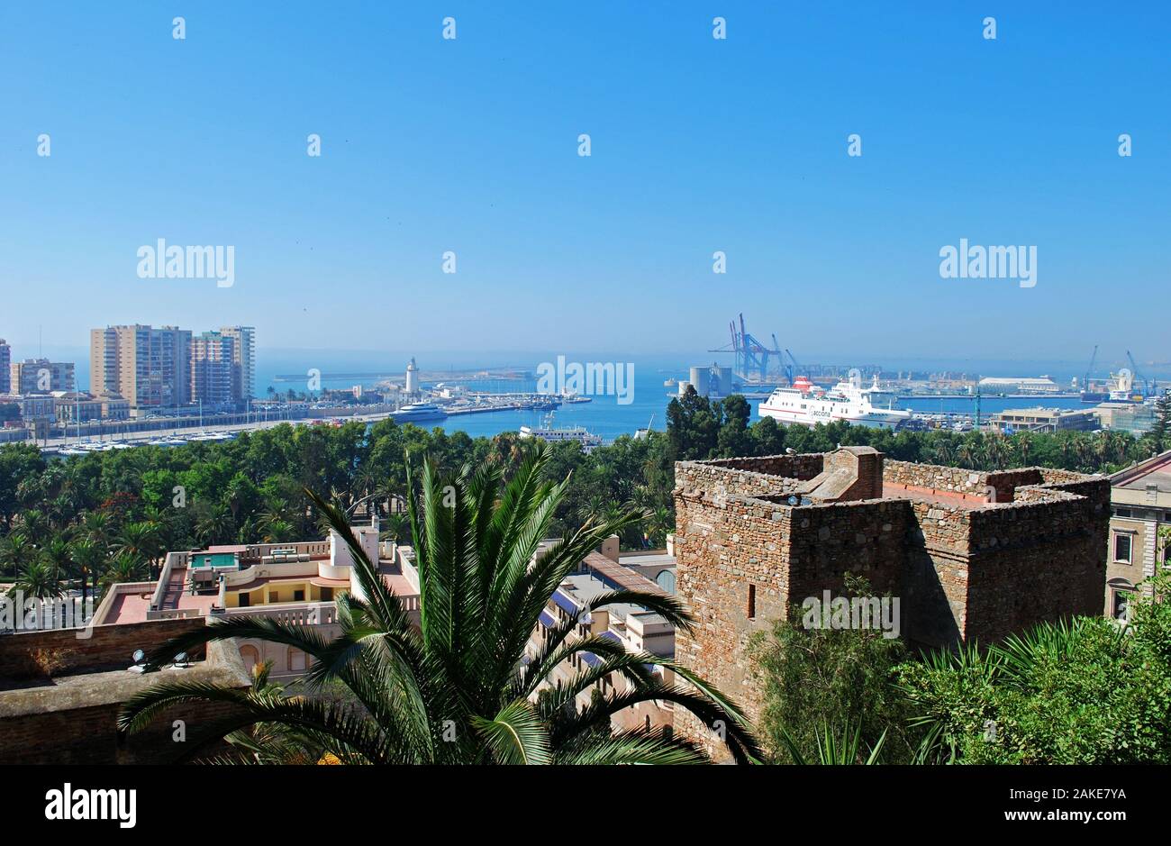 Elevated harbour view with the castle walls and Christs Gate in the foreground, Malaga, Malaga Province, Andalucia, Spain. Stock Photo