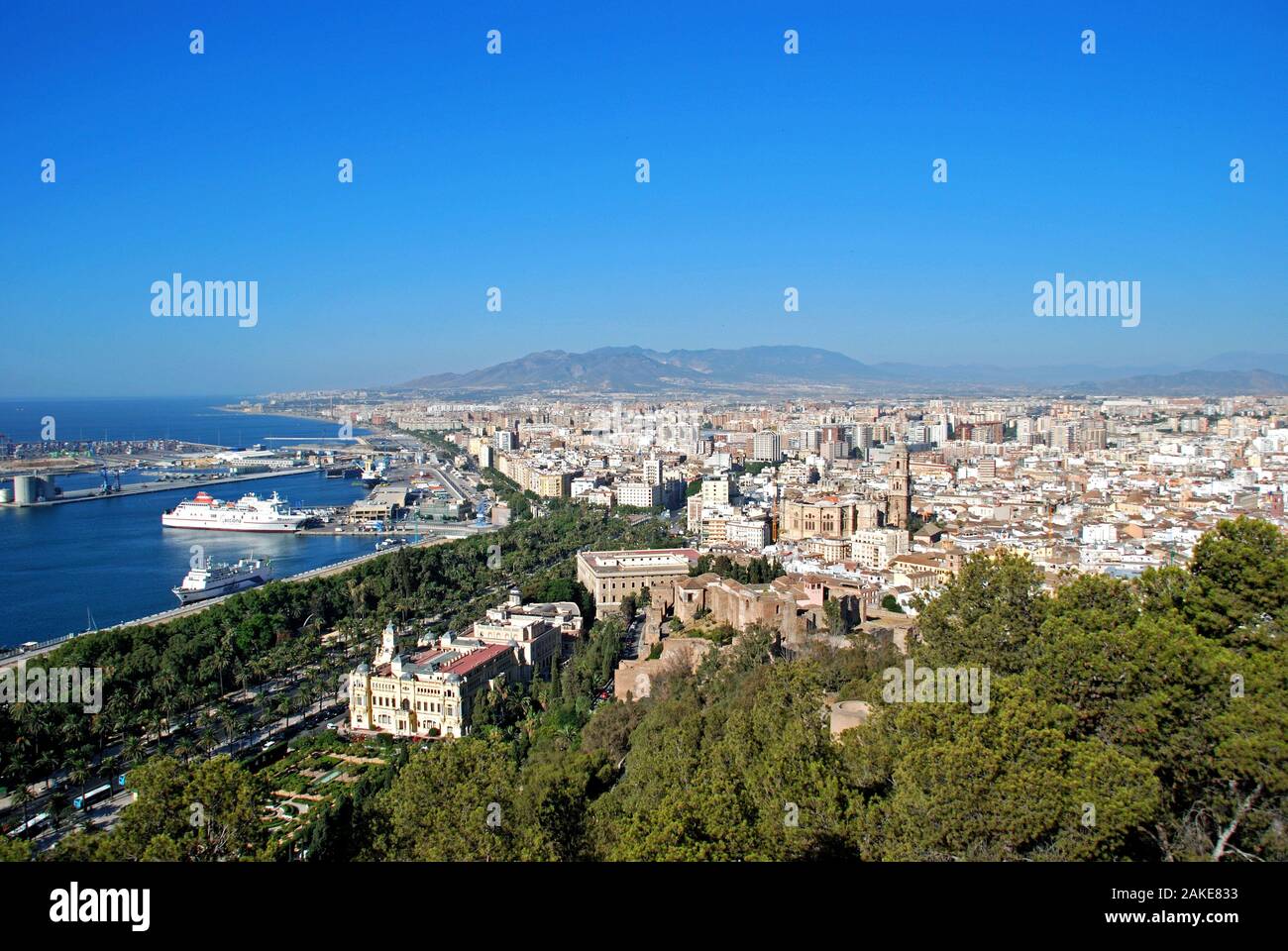 Elevated view of the harbour and city with the former city hall and parts of the castle in the foreground, Malaga, Spain. Stock Photo