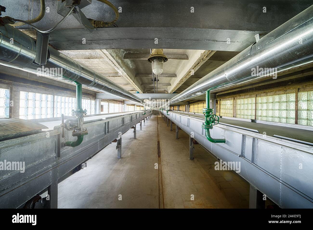 Conveyor belts and pipes, part of chain machinery for disposing and processing waste material Stock Photo