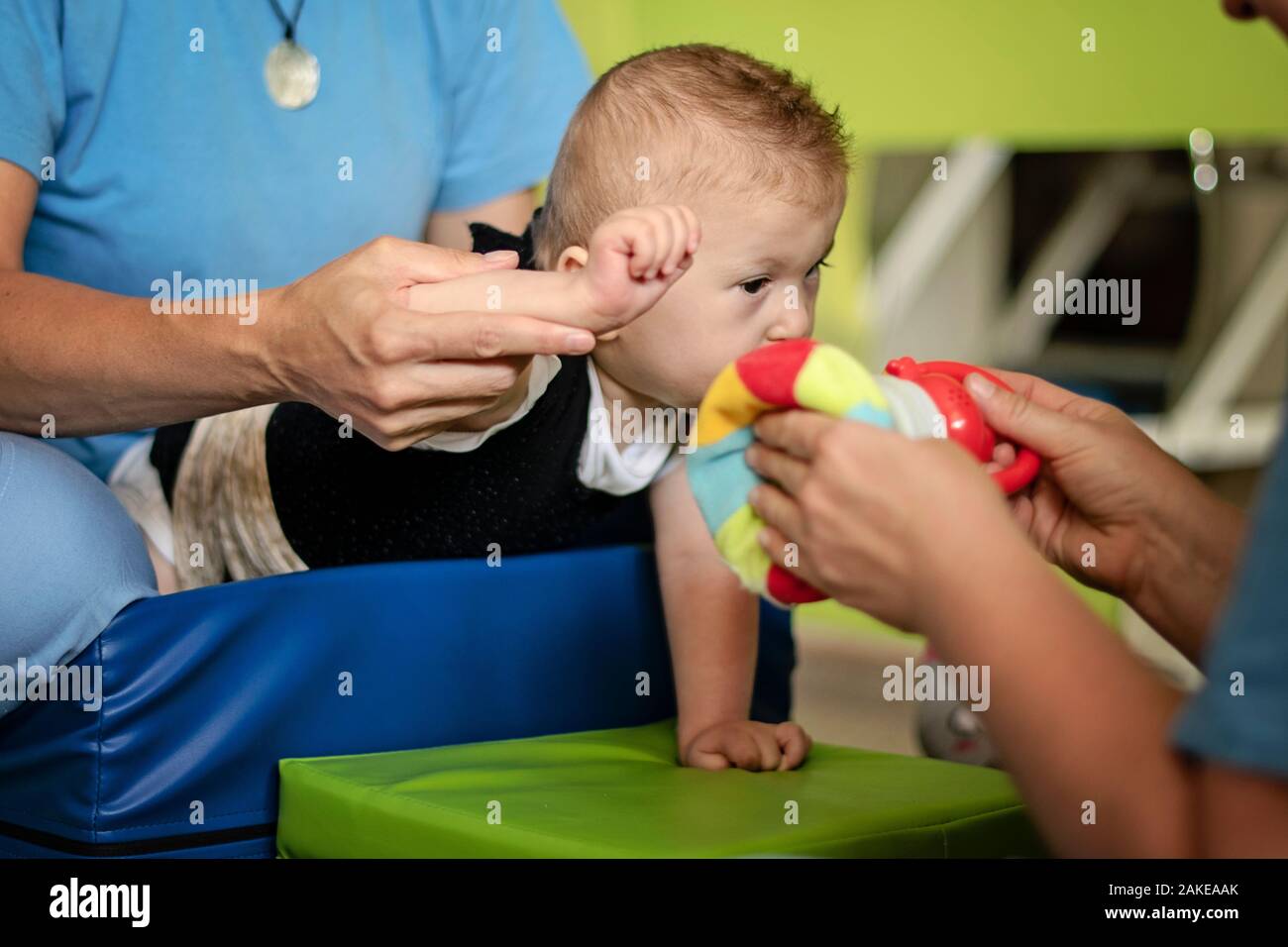 Portrait of a smiling baby with cerebral palsy on physiotherapy in a