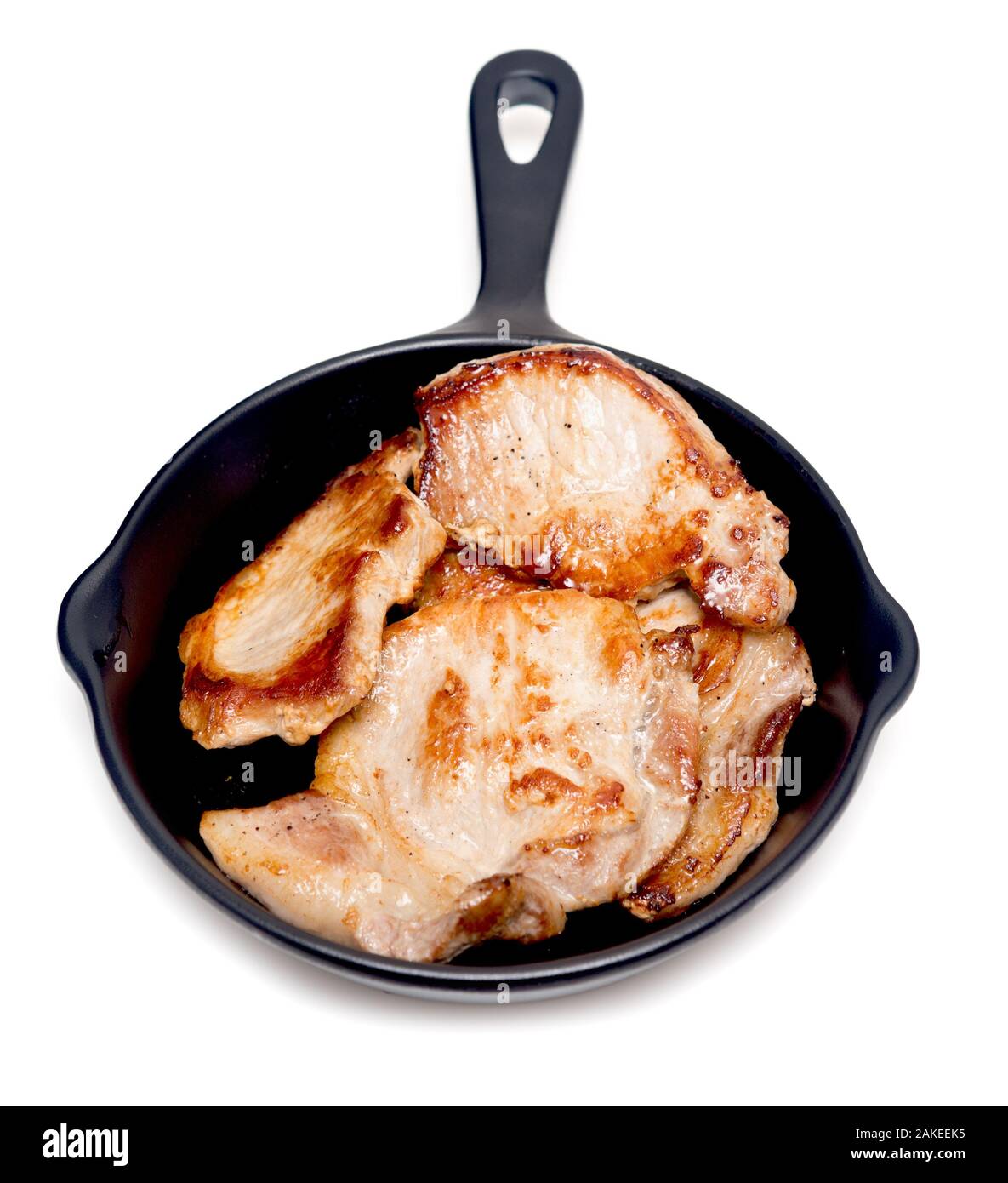 Fried pork meat in a pan isolated on white background Stock Photo - Alamy