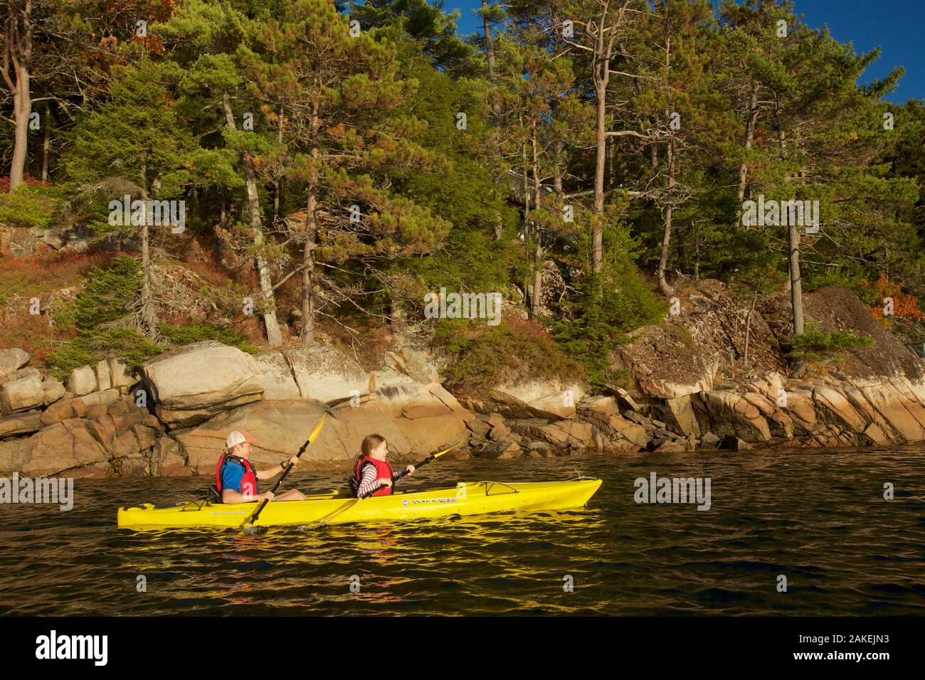 Boy and girl kayaking, Acadia National Park, Maine, USA. October 2013