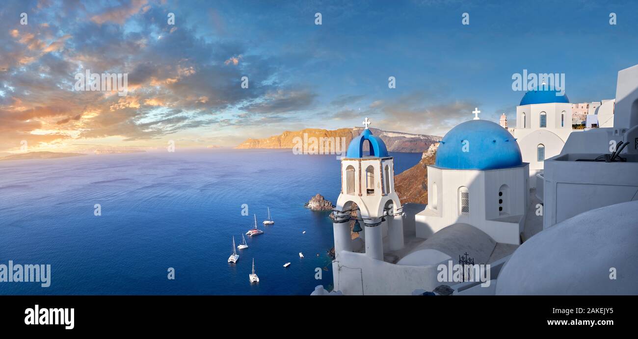 Panoramic sunset over the traditional Greek Orthodox churches of Oia (ia), Cyclades Island of  Thira, Santorini, Greece.  The settlement of Oia had be Stock Photo