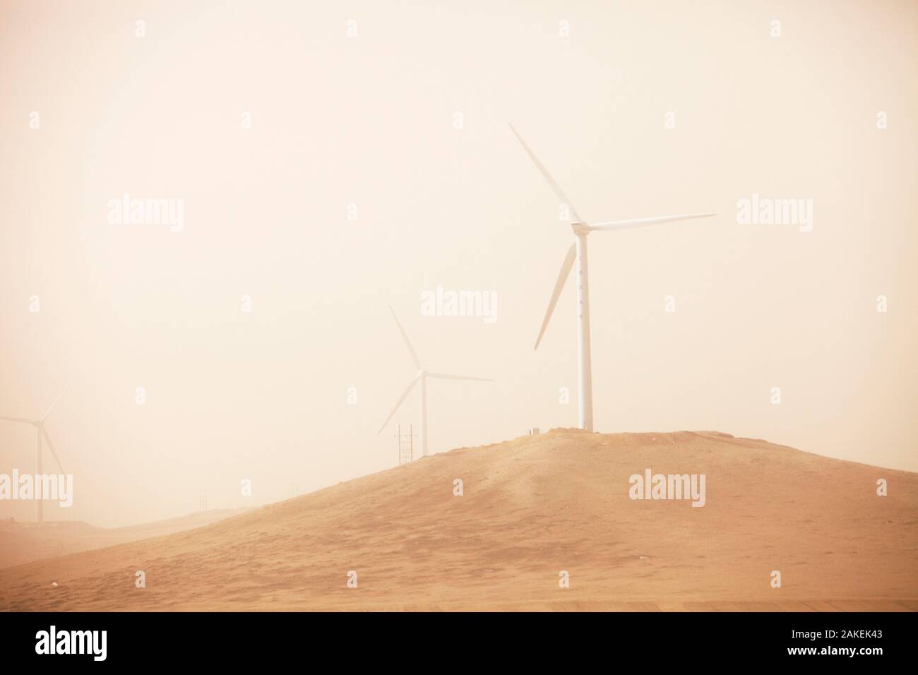 Wind farm seen through haze of a dust storm. Inner Mongolia, China, March 2009. Stock Photo