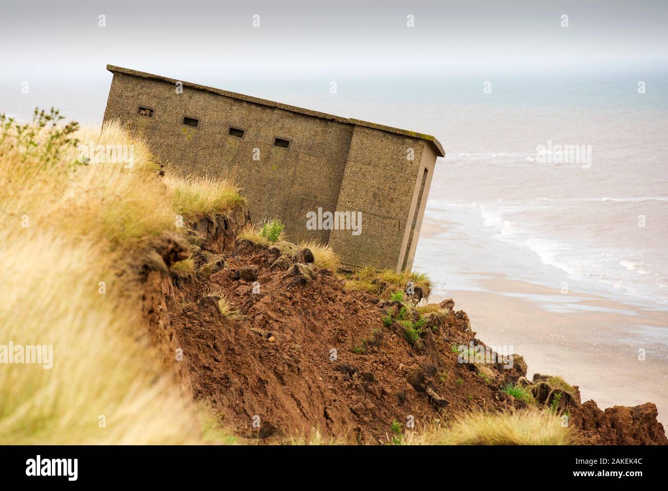 Second World War lookout post leaning over eroding cliff near Aldbrough, Yorkshire, England, UK. August 2013. Stock Photo