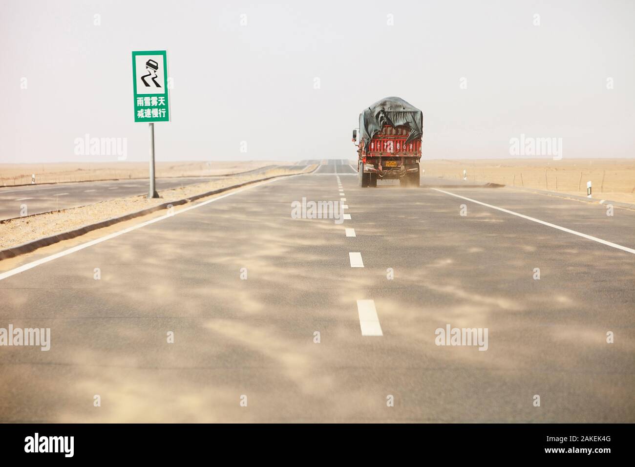 Dust storm blowing sand across highway in Inner Mongolia during severe drought, China, March 2009. Stock Photo